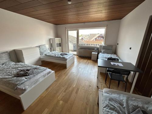 a large room with two beds and a desk at Weedenhof in Zornheim in Zornheim