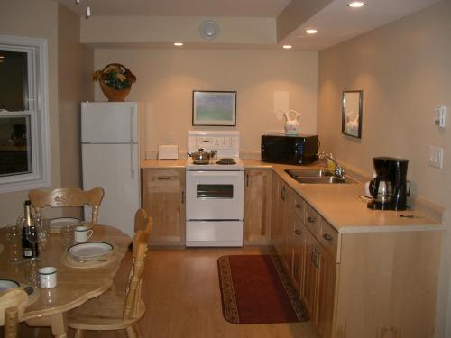 a kitchen with a white refrigerator and a table at The View Lodgings in Princeton