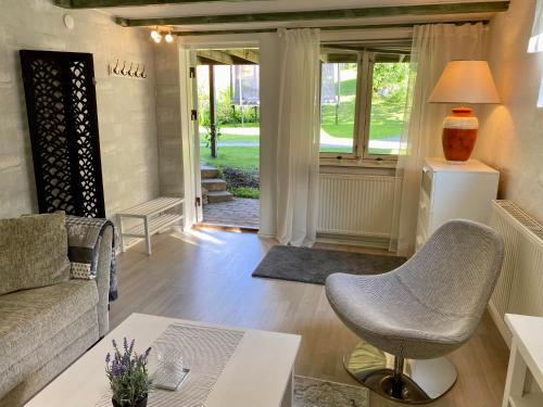 a living room with a couch and a chair at Lower floor of 50 sqm in nice villa with parking in Stockholm