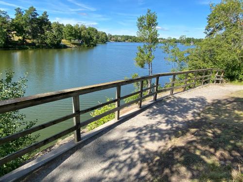 a bridge over a river next to a body of water at Lower floor of 50 sqm in nice villa with parking in Stockholm