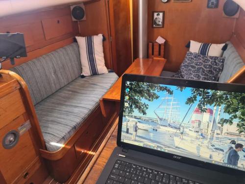 a laptop computer sitting on a desk in a boat at Husbåten Vega 1 Göteborg City in Gothenburg