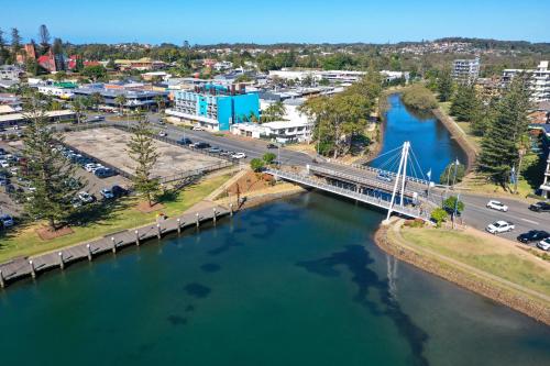 an aerial view of a bridge over a river at Palm Court Motor Inn in Port Macquarie