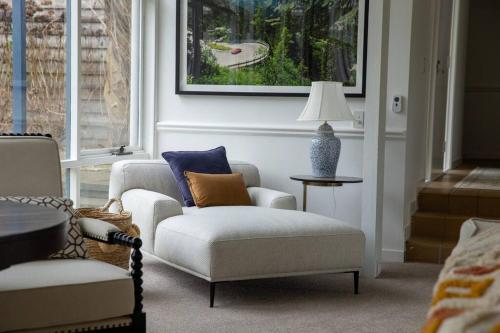 a living room with a couch and a chair and a lamp at Finsbury House - Luxury 8 Bedroom Farm Homestead with Pool in Kilmore