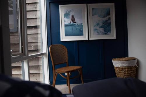 a blue room with a chair and pictures on the wall at Finsbury House - Luxury 8 Bedroom Farm Homestead with Pool in Kilmore