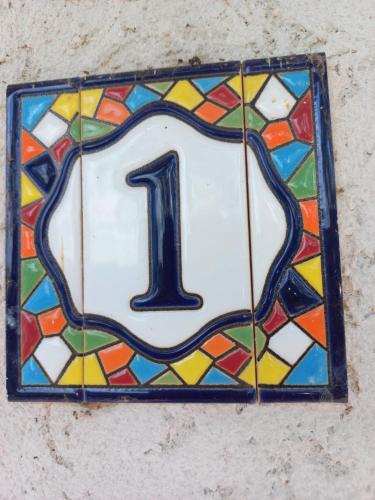 a glass tile with the number one on a wall at Stuffino Crisan in Crisan