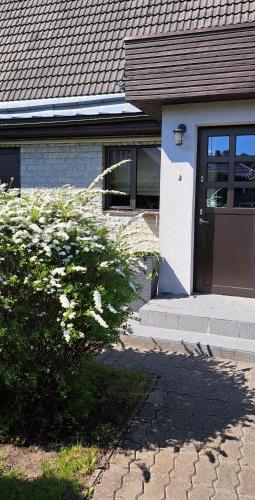 a house with a door and a bush in front of it at room to the east in Viimsi