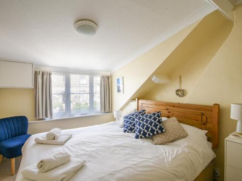 a bedroom with a large bed with towels on it at 3 Cobb View in Lyme Regis