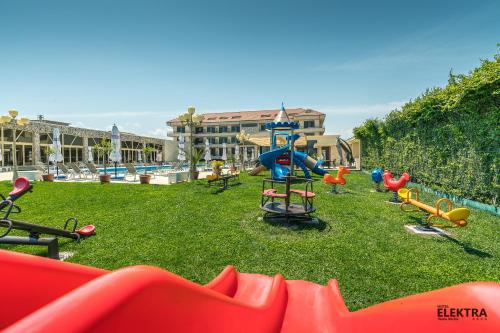 a playground with a bunch of play equipment on the grass at Elektra Vama Veche in Vama Veche