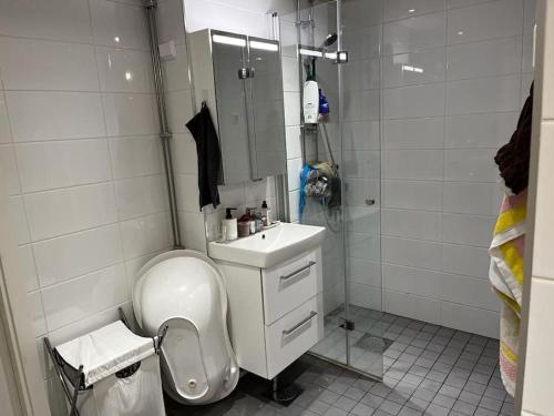 a bathroom with a toilet and a sink and a shower at 2 Bedroom's 1 sitting room Majesty Palace in Espoo
