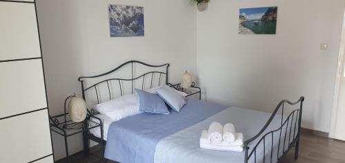 a bedroom with a blue bed with two towels on it at Apartments Stari Pavle in Brela