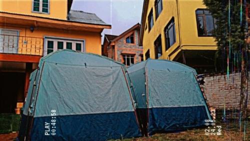 two tents in a yard in front of a house at Zions Camping sight in Srinagar