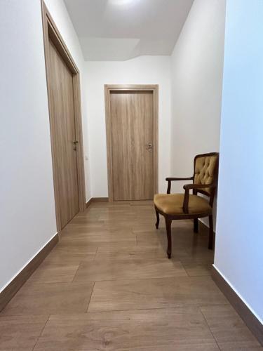 an empty hallway with a chair and a door at Agriturismo Poggio Ajano in Abbazia di Santa Maria in Selva