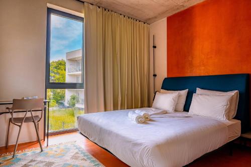 a bedroom with a bed with a large window at Moro Inn in Korčula