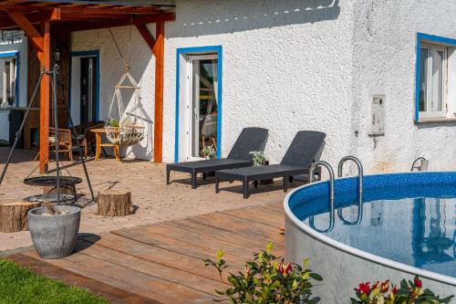 a patio with a swimming pool next to a house at Ranczo Łubowice - wynajmij sobie spokój in Łubowice