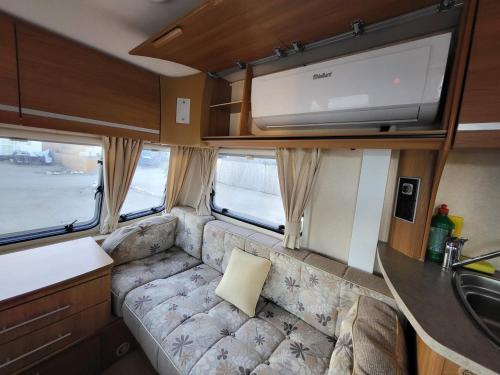 a couch in the back of an rv with a sink at Camping Albox in Albox