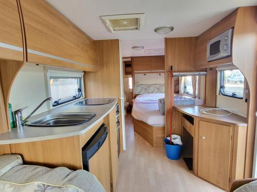 a small kitchen with a sink and a bedroom at Camping Albox in Albox