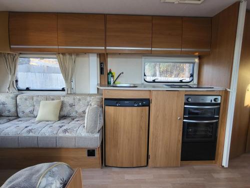 a small kitchen in an rv with a sink and a stove at Camping Albox in Albox