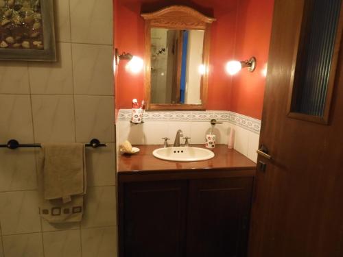 y baño con lavabo y espejo. en Casa rústica en Santiago del Estero