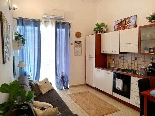 uma sala de estar com um sofá e uma cozinha em Quattro Canti Valù em Palermo
