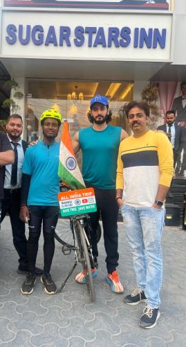 a group of men standing in front of a store at Sugar Stars Inn in Varanasi
