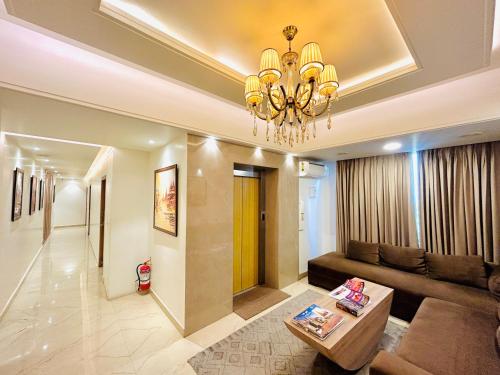 a living room with a couch and a chandelier at Sugar Stars Inn in Varanasi