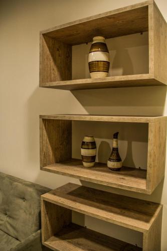 a shelf with vases sitting on it at Blu Apart Hotel in Mogi-Guaçu