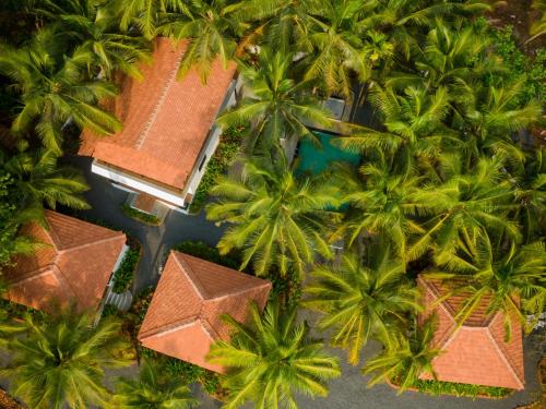 an overhead view of a resort with palm trees at Pont Bleu Suites in Canacona