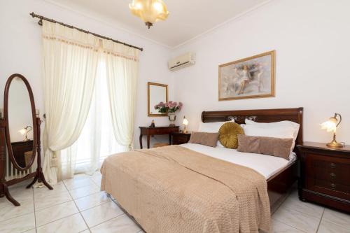 a bedroom with a large bed and a mirror at La Casa Di Nina in Laganas
