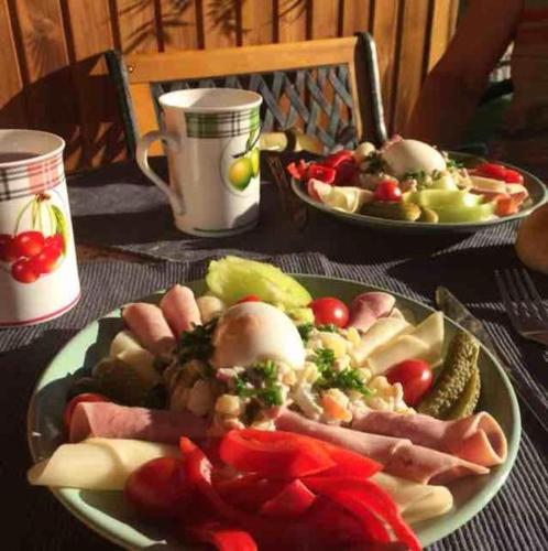 a table with two plates of food on a table at Apartmany Žatec in Žatec