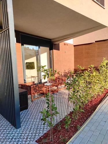 a patio with tables and benches on a building at Boutique Apartment Mostar in Mostar
