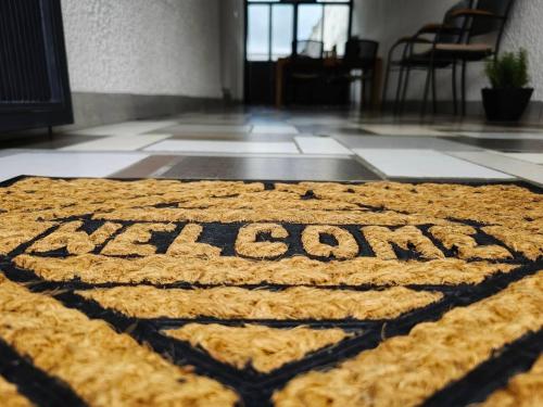 a rug with the word asylum on a floor at MARIJA APARTMAN in Osijek