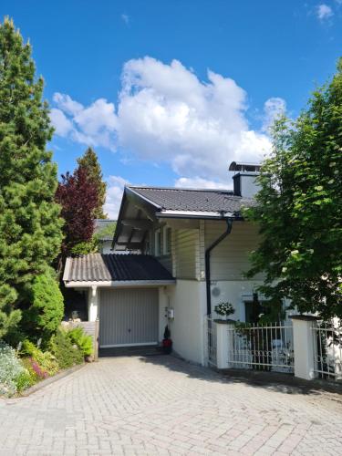 a house with a driveway in front of it at Haus am Sonnberg 24 in Uttendorf