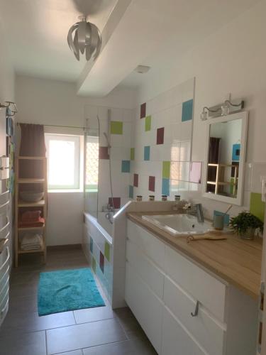 a bathroom with a sink and a mirror at YOGAILO maison de charme in Colombiers
