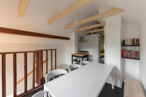 a dining room with a white table and chairs at Appleby Apartments Kersnik in Bohinj