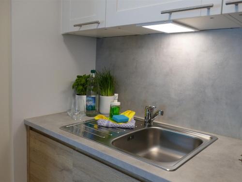 a kitchen counter with a sink in a kitchen at Pension Maiglöckchen in Ostseebad Karlshagen