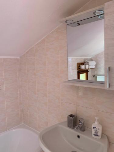 a bathroom with a tub and a sink and a mirror at T V B - Vacanze Imperia in Imperia