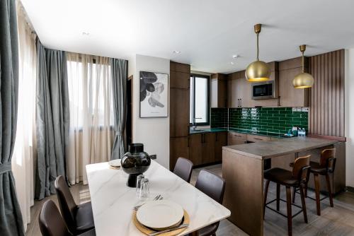 a kitchen and living room with a table and chairs at Zara Garden Hotel and Apartments in Kampala