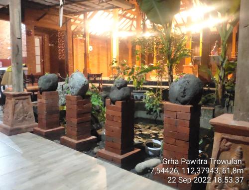a group of stone statues in a room at GRHA PAWITRA TROWULAN in Trowulan