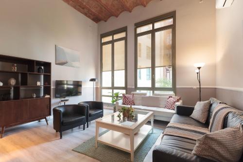 a living room with a couch and a table at LetsGo Paseo de Gracia in Barcelona