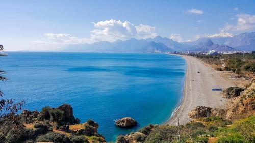a view of a beach with mountains in the background at MY Garden View in Antalya