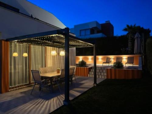 a patio with a table and chairs under a canopy at Casa da alegria in Vau