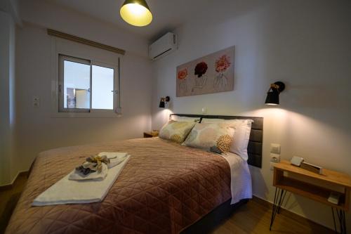 a bedroom with a bed with a tray on it at Chic Apartment in Nature, 5-min walk to the Beach in Kalamata