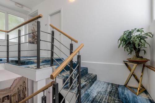 a staircase in a house with a potted plant at Annex building of Art Hotel in Split