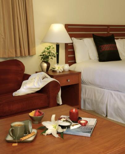 a hotel room with a bed and a table with flowers at West Sonoma Inn & Spa in Guerneville
