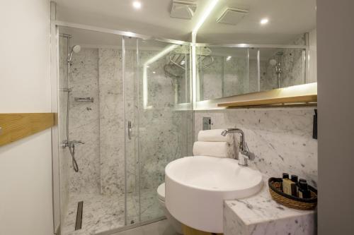 a bathroom with a toilet and a shower and a sink at Blue Alle Alaçatı in Alaçatı