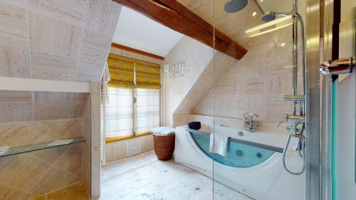 a bathroom with a bath tub and a shower at Besharat Gallery & Museum in Barbizon