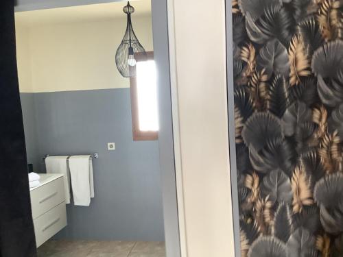 a bathroom with a wall mural of birds at la dolce farniente in Biaudos