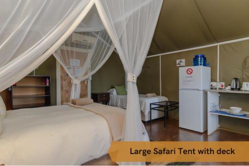 a large safari tent with a bed in a room at Crocodile Bridge Safari Lodge in Komatipoort