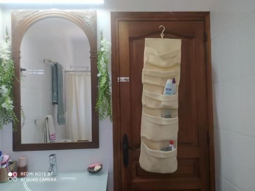 a bathroom with a door with towels on a rack at Habitación privada en casa particular, montaña in Olesa de Bonesvalls