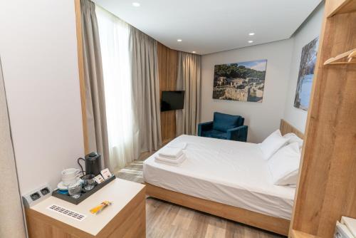 Postel nebo postele na pokoji v ubytování Titania Hotel